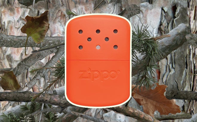 Zippo 12-hour hand warmer in blaze orange on realistic 3D forest camo background