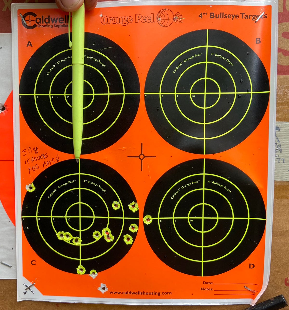 15 rounds at 50 yards with a peep sight in direct sunlight... this is not bad at all. Pen point indicates point of aim. (Photo © Russ Chastain)