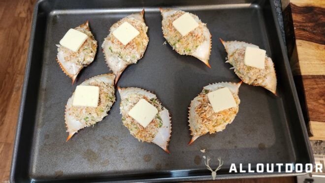 Pat of butter on top of each stuffed deviled crab shell